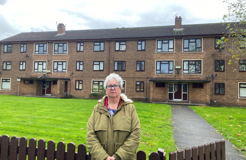 Cllr. Vida Wilson in front of the three blocks in Berrylands Rpad