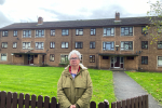 Cllr. Vida Wilson in front of the three blocks in Berrylands Rpad